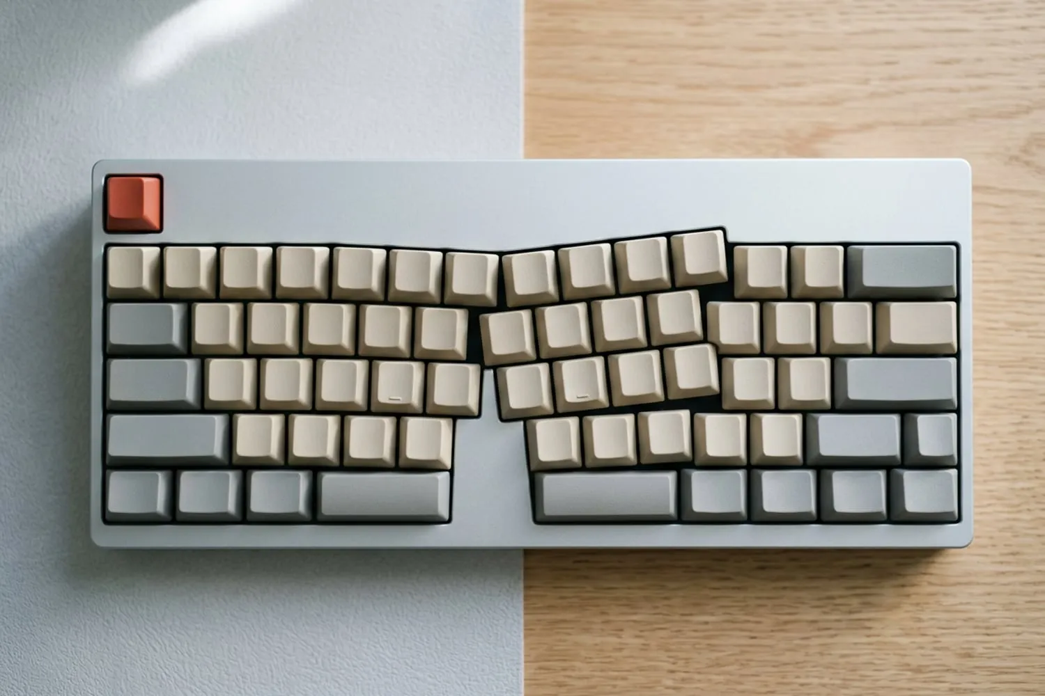 A beige keyboard seen from straight above, every keycap blank, its three letter rows staggered so that each column of keys slants up and to the left